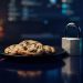Plate of chocolate chip cookies next to a metal padlock and a glowing toggle switch, symbolising cookie consent and data privacy